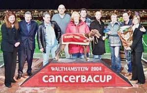 Race 11 ‘Congratulations to Donna on Running the Marathon Stakes’ CancerBACUP supporter fundraising manager, Jo Douglas and Paul Whitehouse present the winning trophy